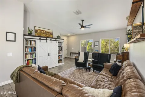 a kitchen with a stove a refrigerator a dining table and chairs