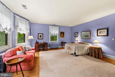 a bedroom with a bed and a couch