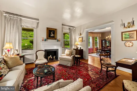 a living room with furniture a fireplace and a window