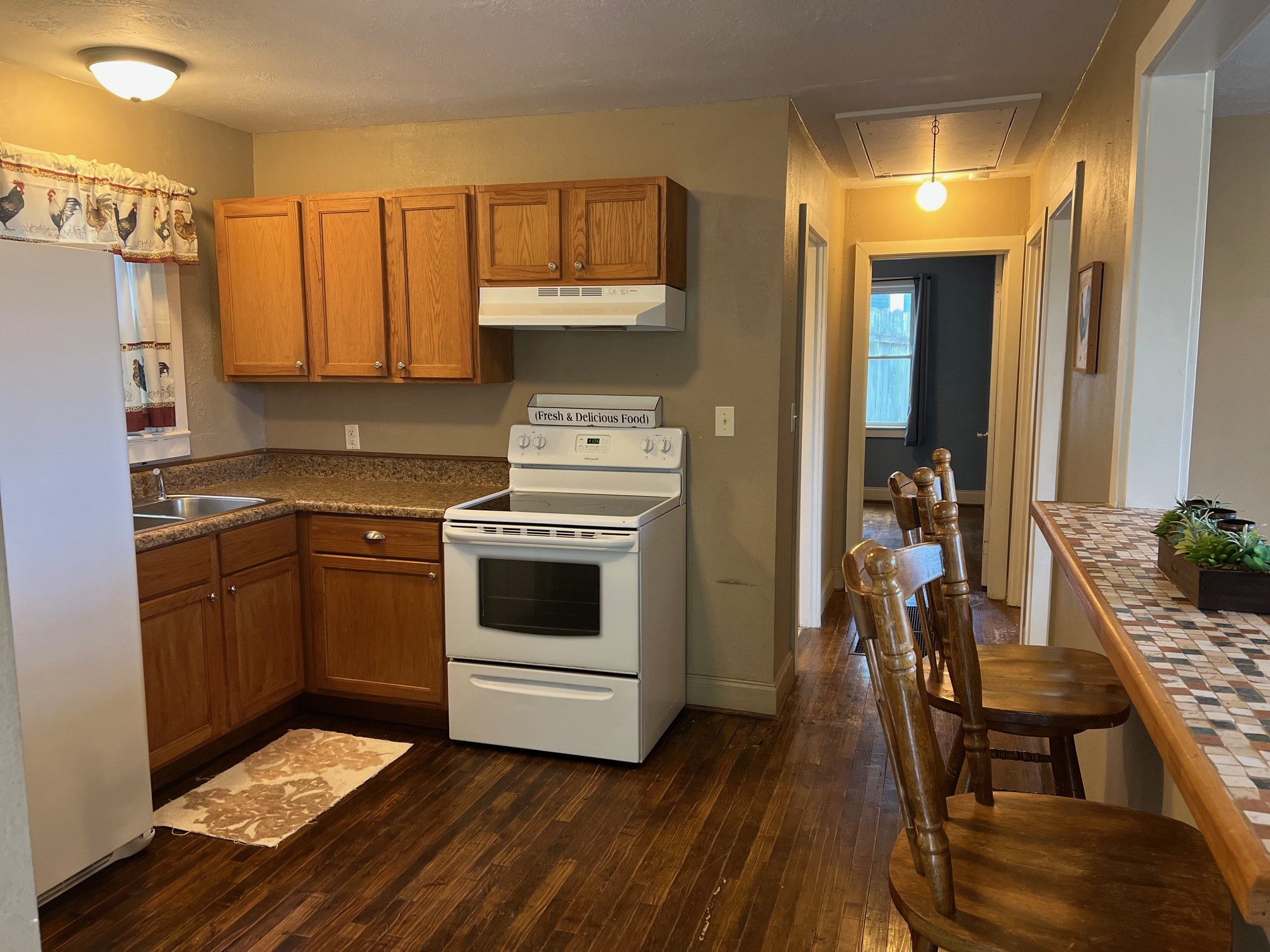 208 North Garner Street Springfield, TN 37172 - Photo 6 of 13 a kitchen with a stove and white cabinets