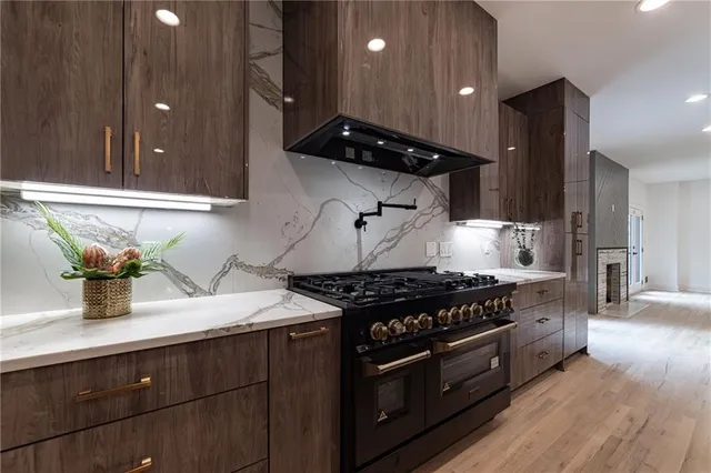 a kitchen with stainless steel appliances a stove a sink and a refrigerator