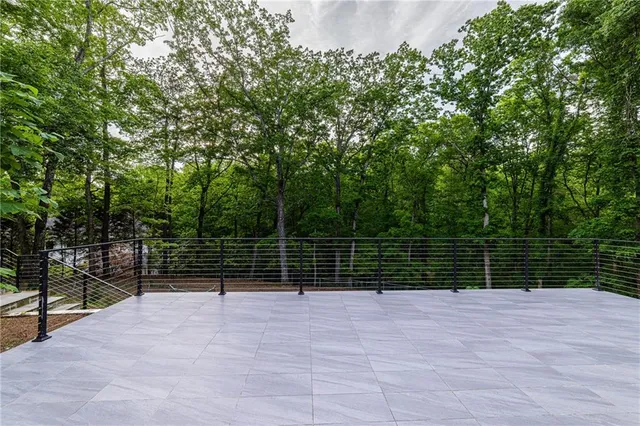 a kitchen with stainless steel appliances granite countertop a stove and a wooden floor
