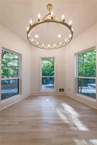 an empty room with closet and fan