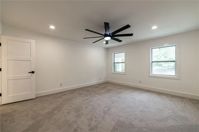 an empty room with wooden floor and entryway