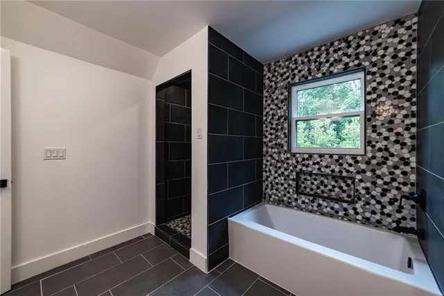 a white bath tub sitting in a bathroom