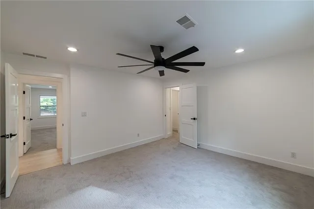 a view of a house with backyard and trees