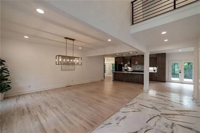 a view of a kitchen with cabinets and wooden floor