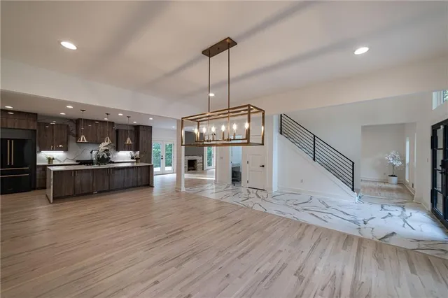a kitchen with stainless steel appliances granite countertop a refrigerator and a sink