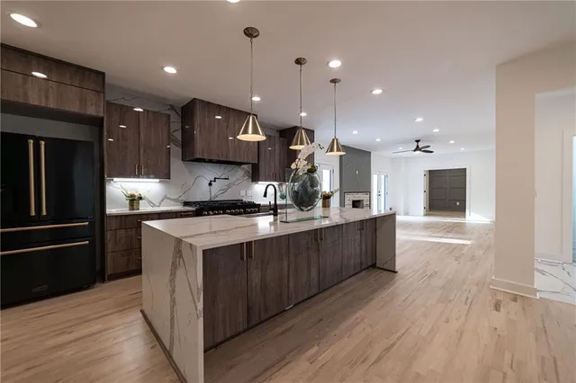 a kitchen with stainless steel appliances granite countertop a stove and a wooden cabinets