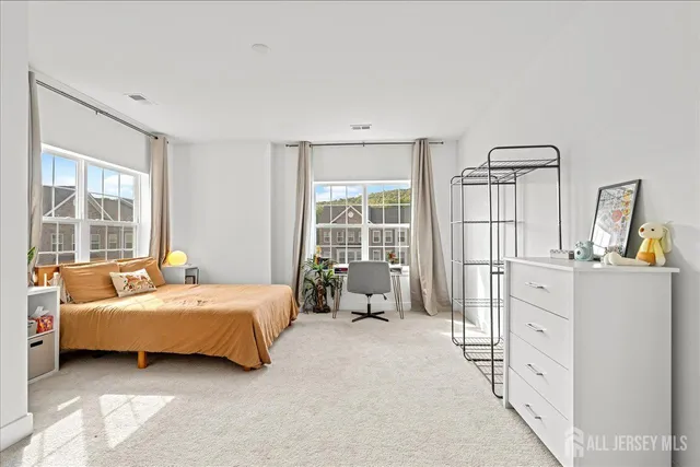 a bedroom with a bed and large window