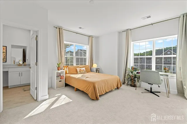 a bedroom with a bed and a large window