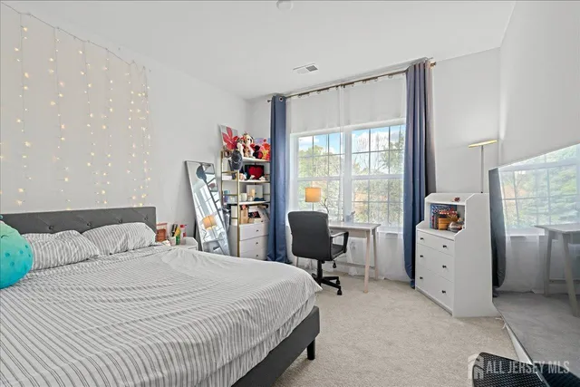 a bedroom with a bed and a chair