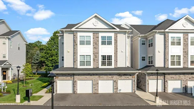 a front view of a house with a garden and plants
