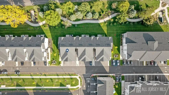 an aerial view of a house with a garden and yard