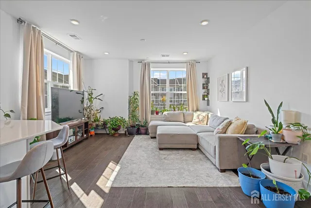 a living room with furniture and a potted plant