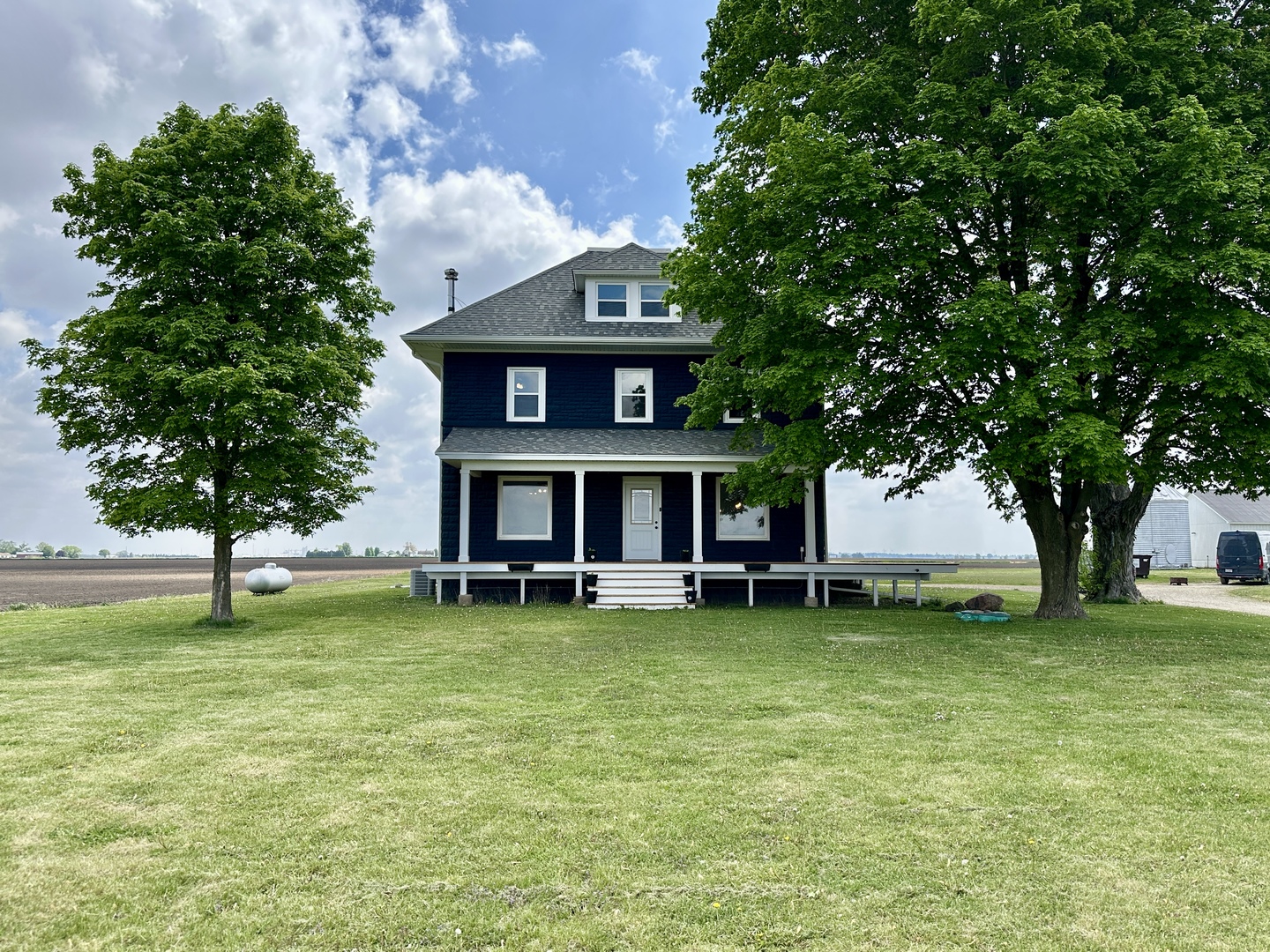 a view of a house with a yard porch and sitting area