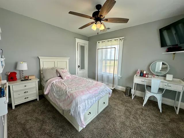 a bedroom with a bed and a flat screen tv