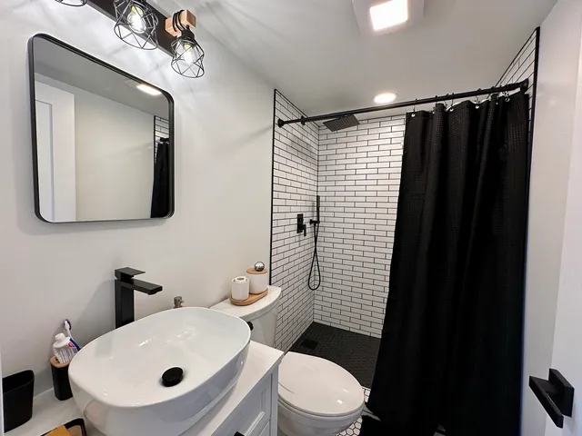 a view of a house with a big yard and a large tree