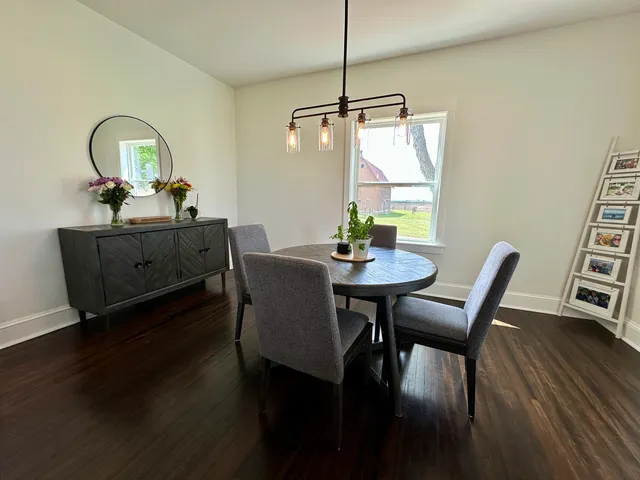 a view of a dining room with furniture window and wooden floor