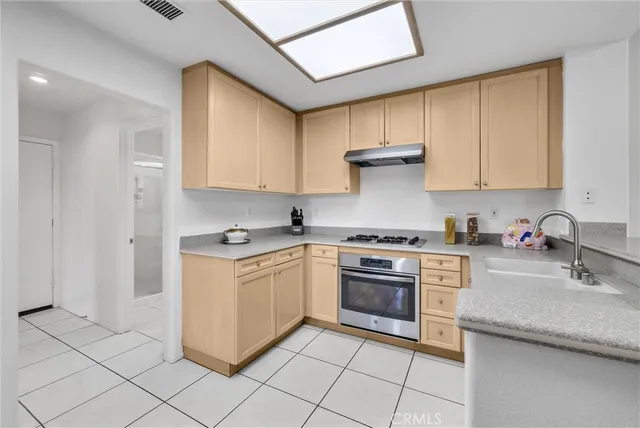 a kitchen with granite countertop cabinets stainless steel appliances and a sink