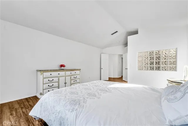 a bedroom with a bed and a dresser