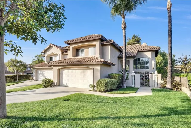 a front view of a house with a garden and yard