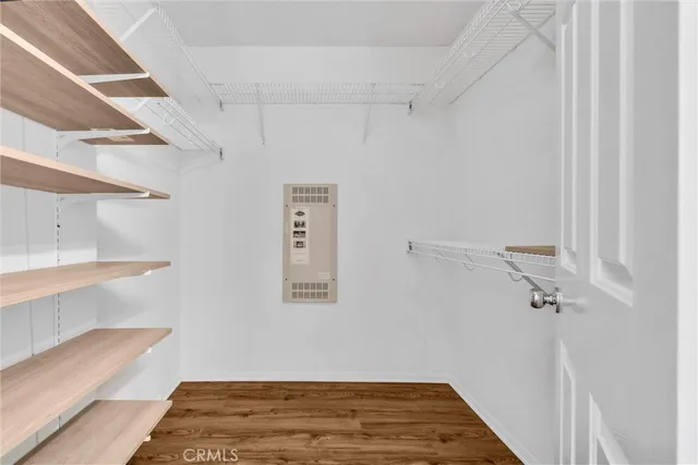 a view of a room with wooden floor and a window