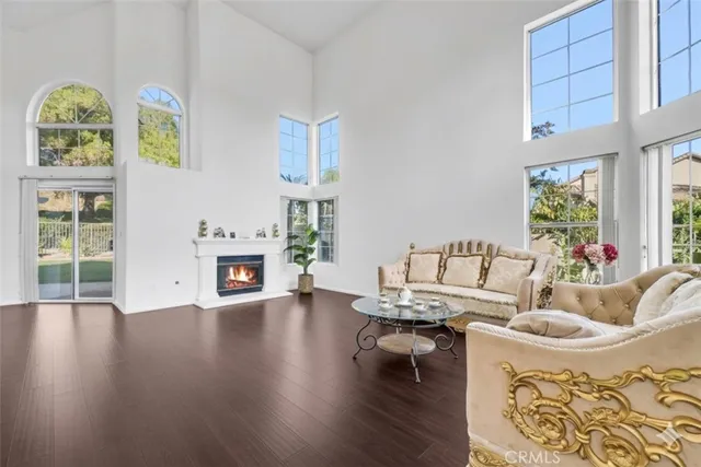 a living room with fireplace furniture and a wooden floor