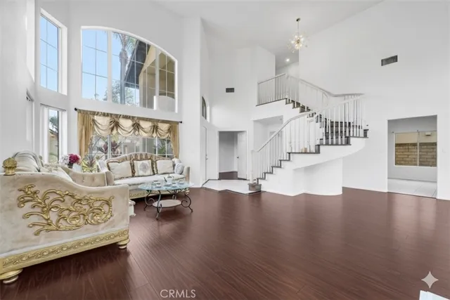 a living room with furniture and floor to ceiling windows