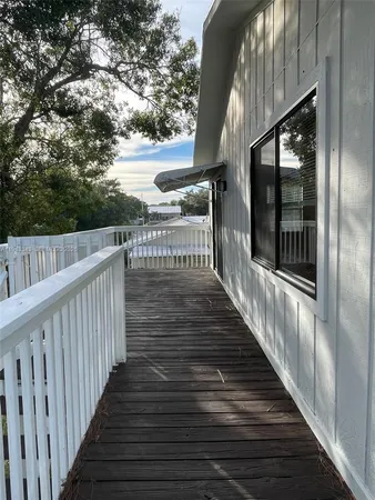 a view of balcony with wooden floor