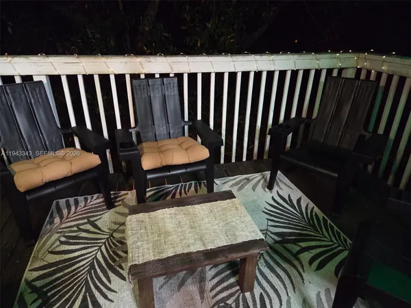 a balcony with table and chairs