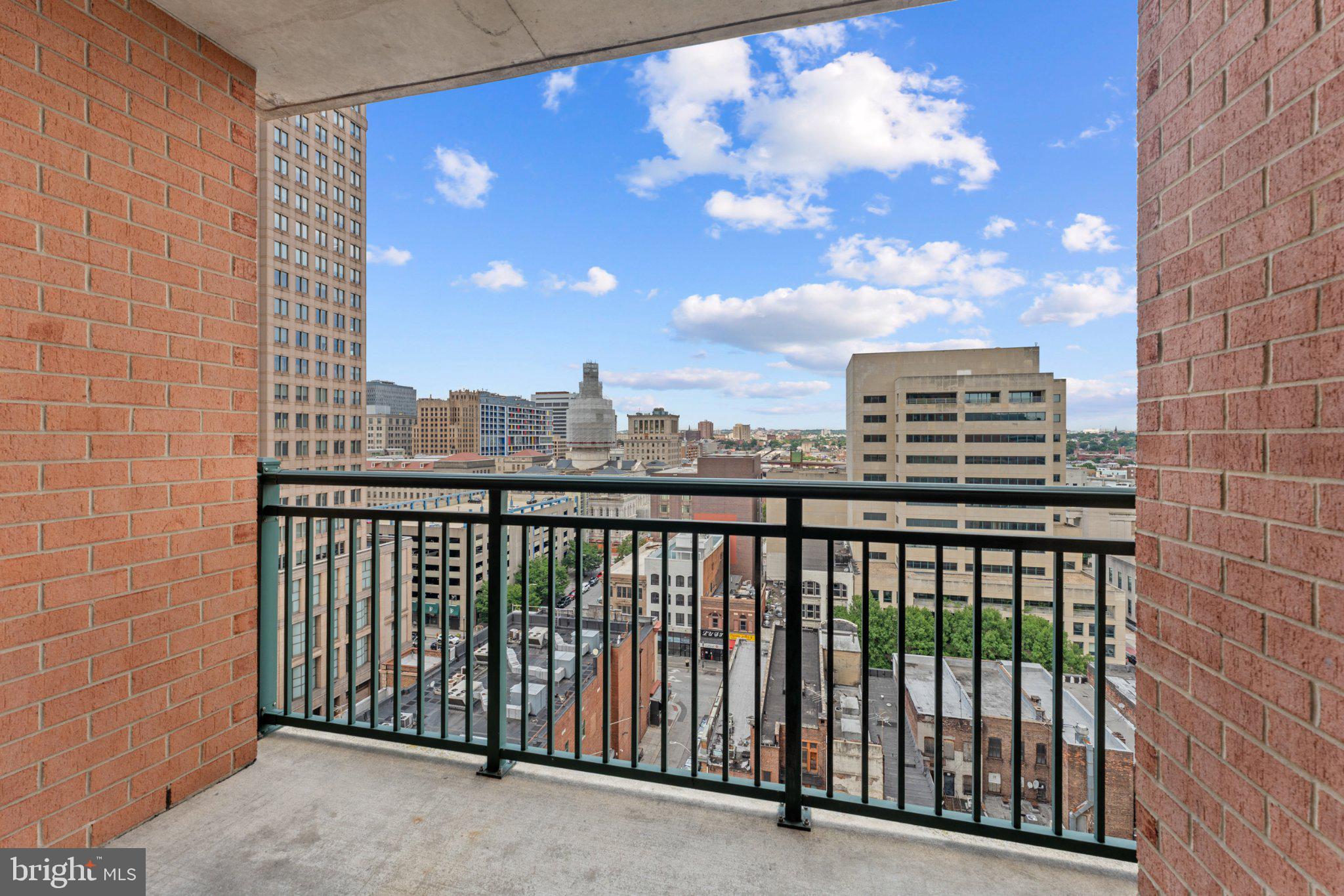 414 Water Street, Unit 1306 Baltimore, MD 21202 - Photo 14 of 29 Urban skyline from a modern balcony.