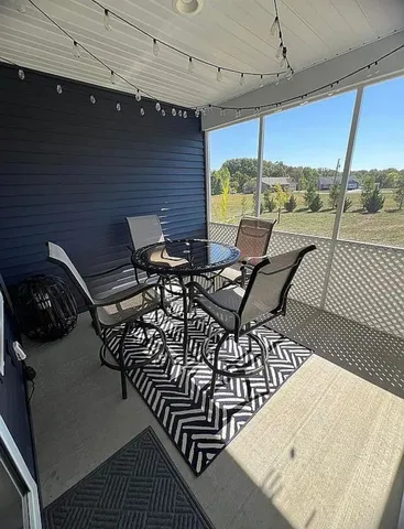 a view of a chairs and table in patio