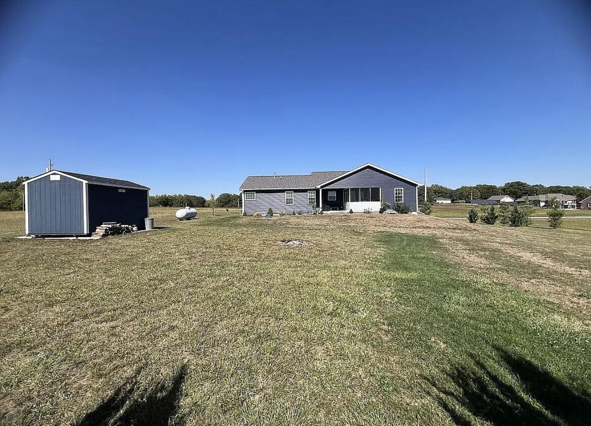 6227 East Sarver Lane Argenta, IL 62501 - Photo 19 of 20 a view of a house with a yard