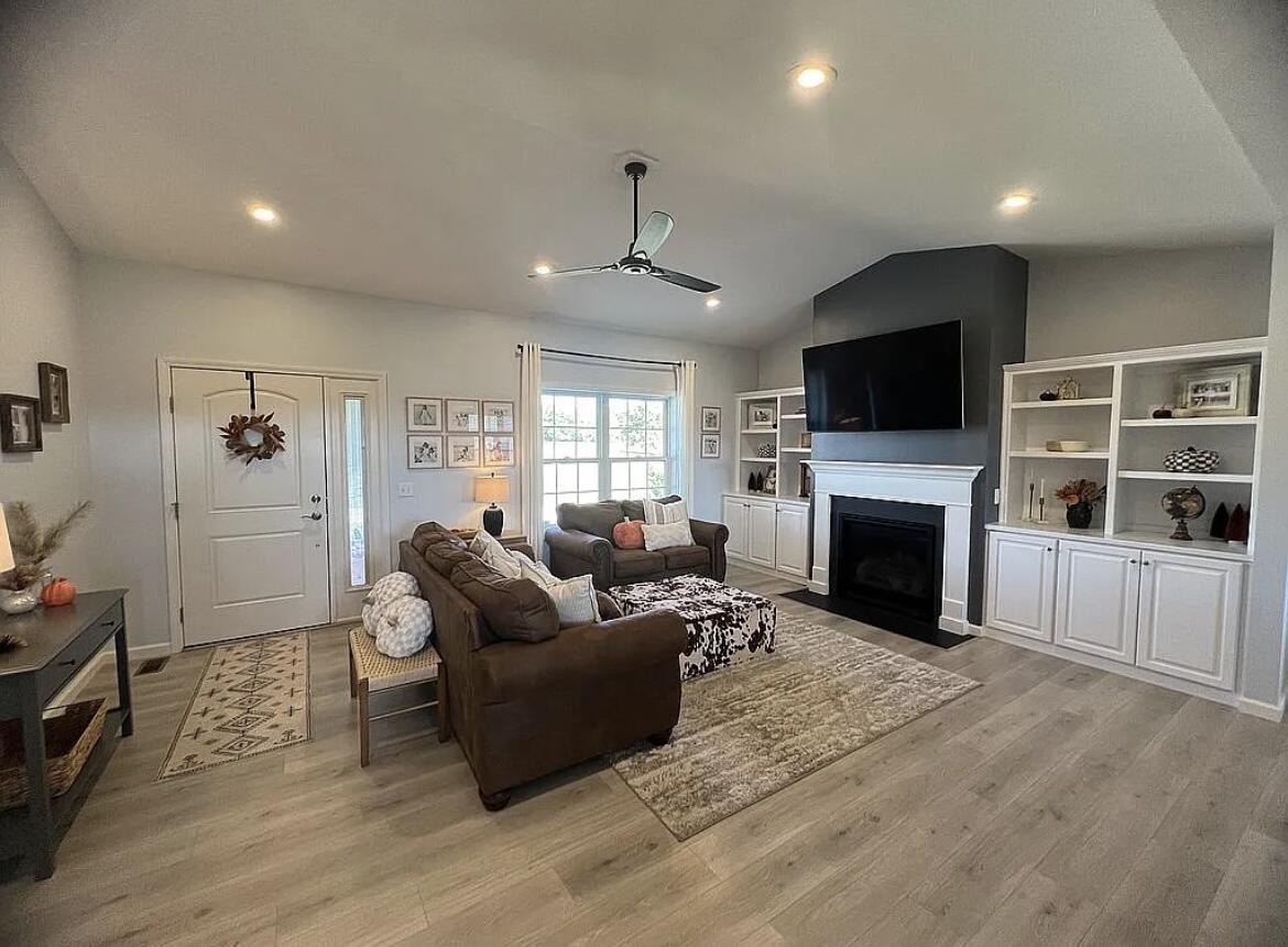 6227 East Sarver Lane Argenta, IL 62501 - Photo 5 of 20 a living room with furniture a fireplace a flat screen tv and a window