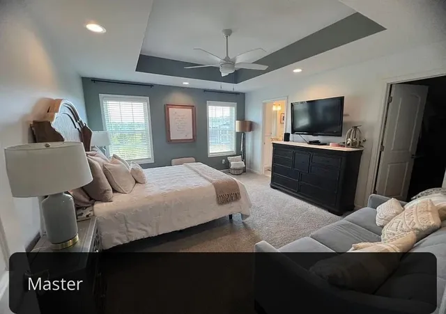 a bedroom with a bed and a television