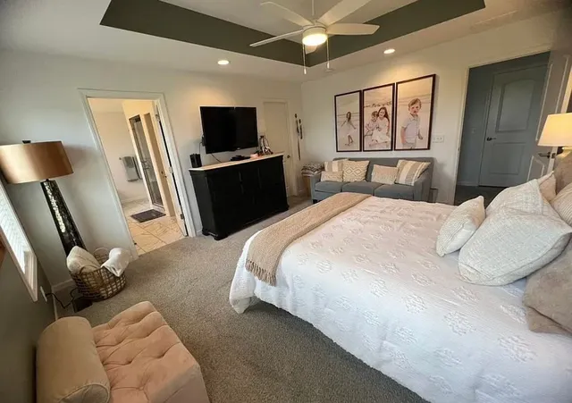 a bedroom with a bed and a flat screen tv