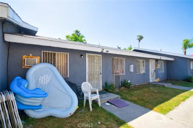 a backyard of a house with table and chairs
