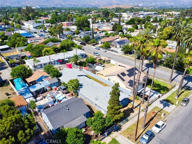 an aerial view of residential houses with outdoor space and street view