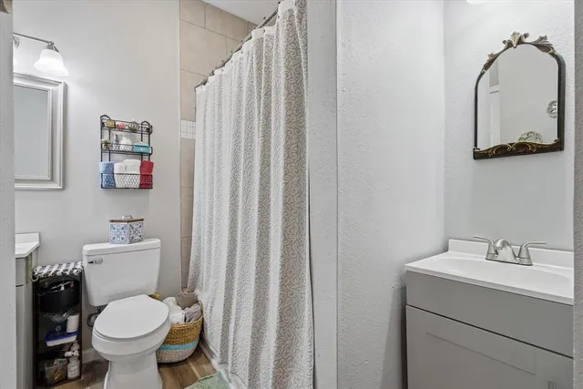a bathroom with a sink a toilet and a mirror
