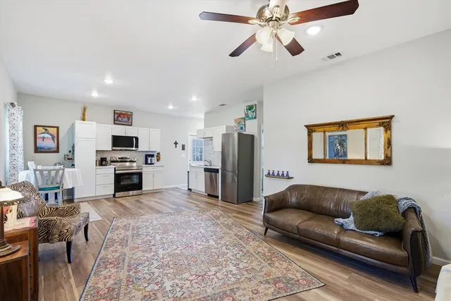 a living room with furniture and kitchen view