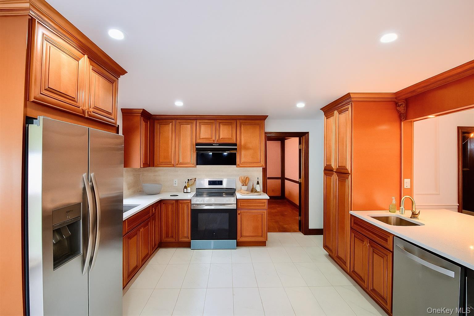 285 Goff Road Livingston Manor, NY 12758 - Photo 8 of 24 Kitchen featuring applianceswith stainless steel finishes,brown cabinets, light stonecountertops, recessed lighting,and tasteful backsplash