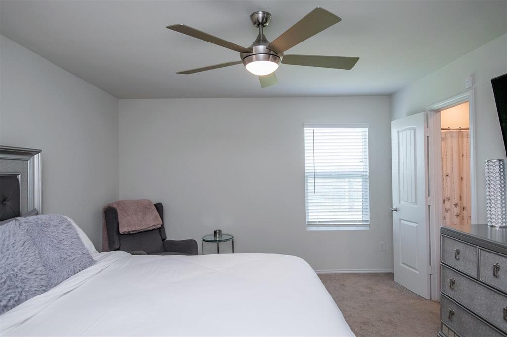 1215 Fairford Road Crandall, TX 75114 - Photo 9 of 20 a bedroom with a large bed and a window