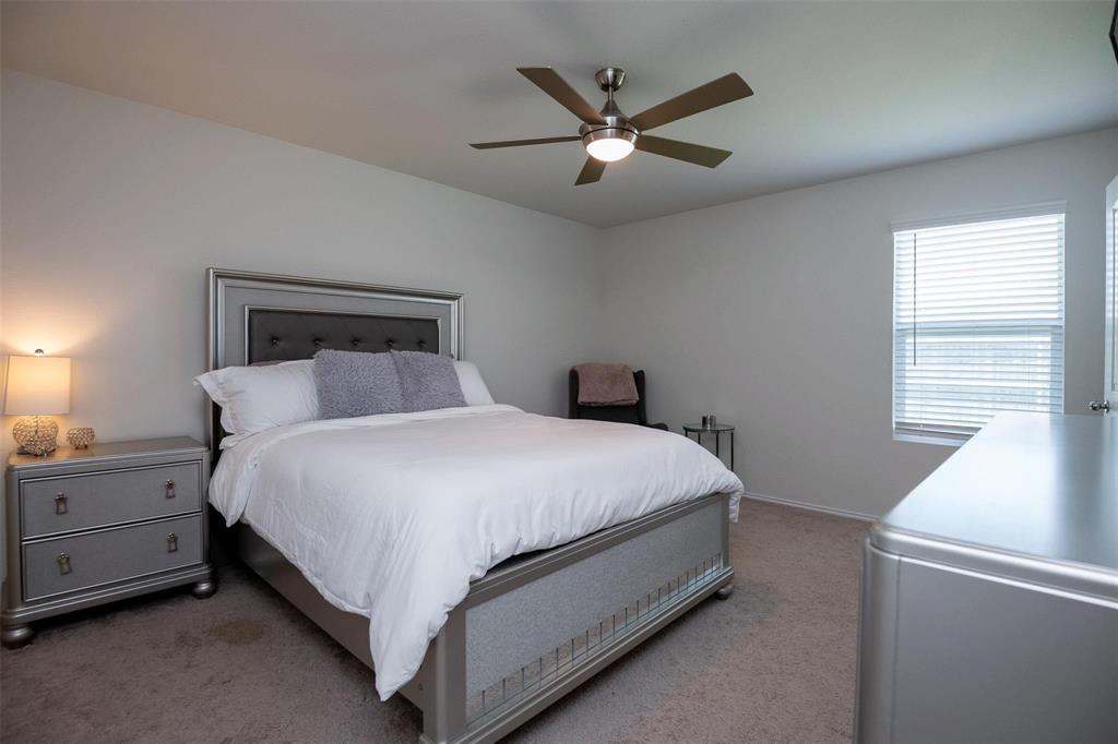 1215 Fairford Road Crandall, TX 75114 - Photo 10 of 20 a large bed sitting in a bedroom next to a window