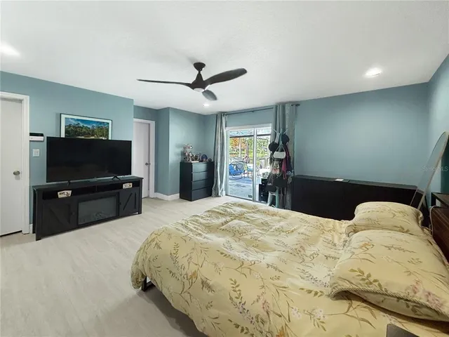 a bedroom with a bed and a television