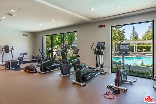 a view of a patio with couches chairs and a fire pit