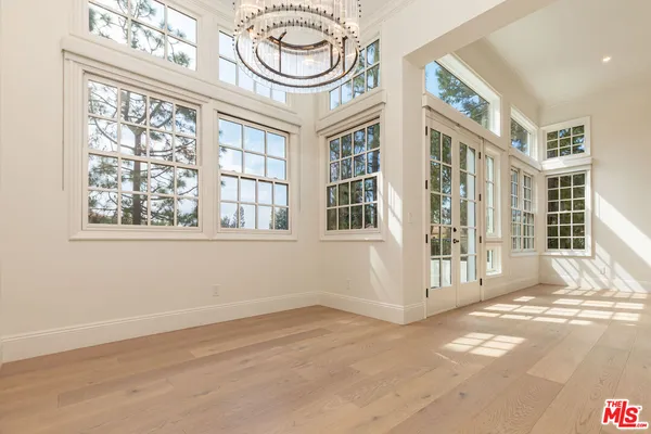 a kitchen with stainless steel appliances granite countertop a white cabinets and a refrigerator