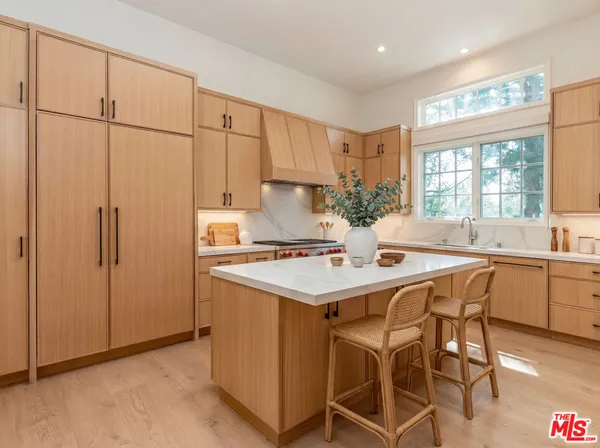 a kitchen with granite countertop a sink stove and refrigerator