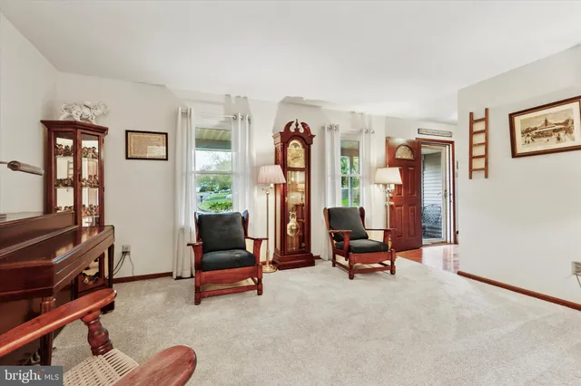 a living room with furniture gym equipment and a window