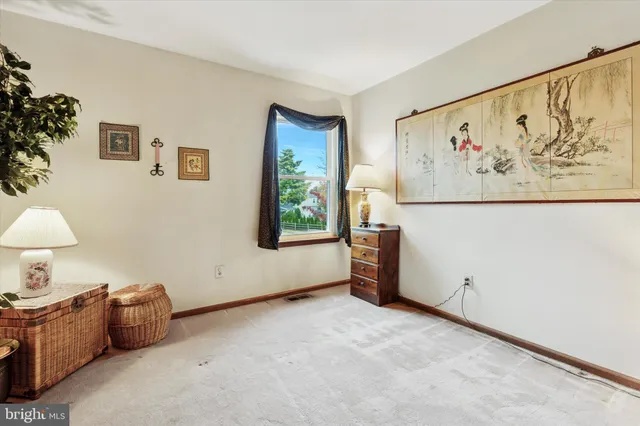 a spacious bedroom with a bed and window